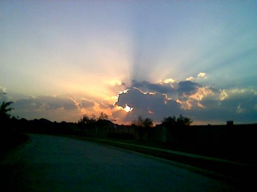 Texas Skies - This photo was taken after a thunderstorm.  We were driving out of a parking lot and looked straight at those clouds.  As soon as we grabbed the camera the rays came shooting out of the clouds.  Awesome!