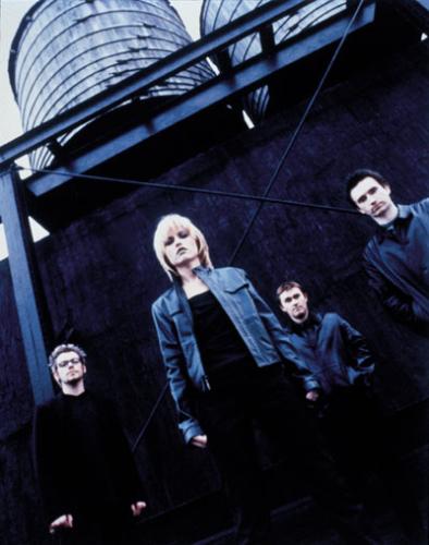 The Cranberries Picture Gallery - Originally, the Cranberries were a band called the Cranberry Saw Us. Brothers Noel and Mike Hogan (guitar and bass, respectively) formed the band in Limerick, Ireland, with drummer Fergal Lawler in 1990. Following the departure of the group's original singer, Niall, the trio placed an advertisement for a female singer. Dolores O'Riordan responded to the advertisement and auditioned by writing lyrics and melodies to some of the band's existing demos. When she returned with a rough version of 'Linger,' the group hired her on the spot. Shortly after she joined, the band recorded a demo tape which they sold in record stores throughout Ireland. After the original run of 300 copies sold out, the group truncated their name to the Cranberries and sent another demo tape, which featured early version of both 'Linger' and 'Dreams,' to record companies throughout the U.K. The tape was made at Xeric studios, which was run by Pearse Gilmore, who would later become their manager. At the time the tape was made, all of the members were still in their late teens.