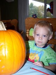 Painting pumpkins - This is my little guy painting his pumpkin.