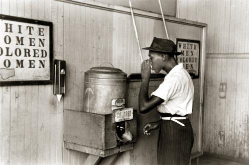 picture of a black man drinking out of a fountain -    this picture was taken after the slavery days were over but before blacks were ever actually able to drink out of the whites water. I hope that no one found this affensive, it wasn't meant to be.