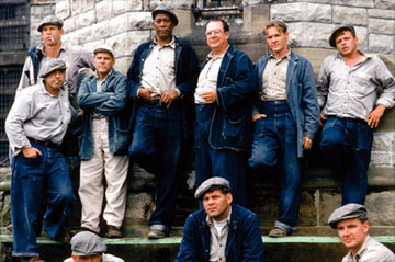 The Shawshank Redemption  - Andy Dufresne, a mild mannered New England banker, is convicted of murdering his wife and her lover. Despised at first by the other inmates because of his introverted manner, Andy slowly forges an unlikely friendship with Red, a seasoned lifer and his gang. Soon, Andy also becomes popular with the prison guards, including the vicious Captain Hadley who offers him protection against the jail's rougher convicts in exchange for financial counseling. The prison warden also takes advantage of Andy's banking knowledge by exchanging privileges for creative bookkeeping. Over a twenty year period, Andy is able to maintain his sanity and dignity in prison not by physical force but by mental force. His smarts and confidence keep him going and he is able to teach the other prisoners that hope is the ultimate means of survival.