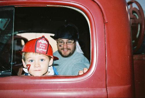 Big Blue Eyes! - Brayden got to have fun in a 1940 firetruck for his birthday!  I LOVE this picture...but it scares me!  Those blue eyes are going to lead to trouble in a few years!!!!
