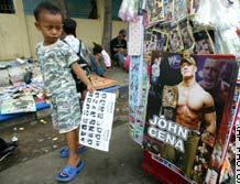 from CNN.com - 
An Indonesian boy looks at a poster of U.S. wrestling star John Cena at a toy stall on a Jakarta, Indonesia, street on Thursday (CNN.com).
