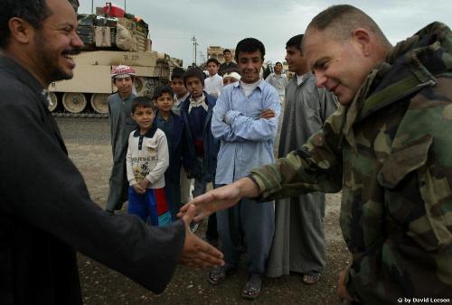 shaking hands - Iraqi greets American soldier