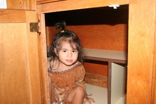 Lydia in the Cupboard - Lydia is dressed as Pochahontas.  She is wearing a Disney(R) costume that her grandma (her dad's mom) bought her for Halloween.  She is 'an Indian in a Cupboard.'  If you don't get it, it's a reference to The Indian in the Cupboard movie directed by Frank Oz.