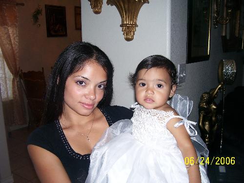 2 beautiful girls - Here is another picture with my daughter and I. Don't we both look so beautiful. This was her one year birthday. That is why she is so dressed up. Me I always look this good!