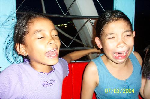 Fun on the Ferris Wheel - I was on it too and screaming but I'm not in this picture... thank heavens. Why were we screaming? Nobody knows.  Taken in the Philippines.
