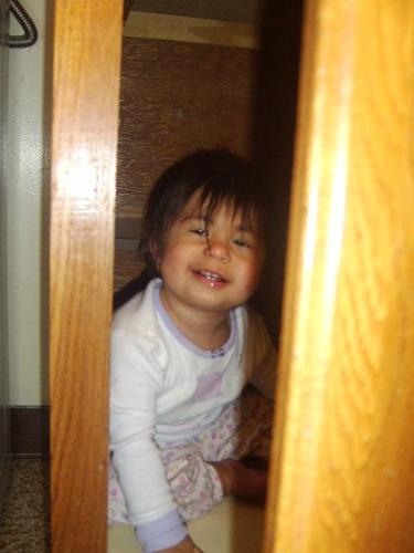 Lydia in the Cupboard as an Infant - She sure loves to hide in there!