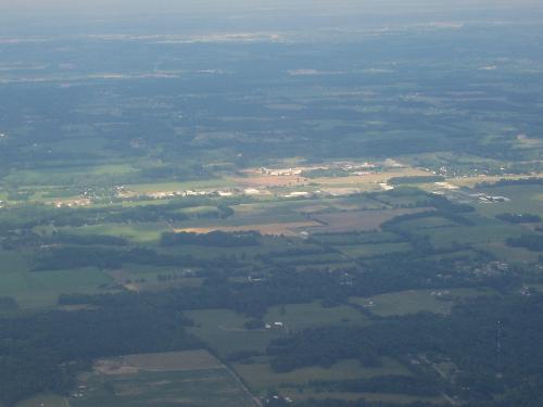 Views from a plane - This is one of my more interesting plane photos. It shows everything cloudy, except for one spot in the middle. It makes me think there is something special with that spot, even though there is nothing extra ordinary about it.