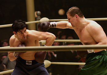 Russell Crowe in Cinderella Man as boxer - During the Great Depression, a common-man hero, James J. Braddock--a.k.a. the Cinderella Man--was to become one of the most surprising sports legends in history. By the early 1930s, the impoverished ex-prizefighter was seemingly as broken-down, beaten-up and out-of-luck as much of the rest of the American populace who had hit rock bottom. His career appeared to be finished, he was unable to pay the bills, the only thing that mattered to him--his family--was in danger, and he was even forced to go on Public Relief. But deep inside, Jim Braddock never relinquished his determination. Driven by love, honor and an incredible dose of grit, he willed an impossible dream to come true. In a last-chance bid to help his family, Braddock returned to the ring. No one thought he had a shot. However Braddock, fueled by something beyond mere competition, kept winning. Suddenly, the ordinary working man became the mythic athlete. Carrying the hopes and dreams of the disenfranchised on his shoulders, Braddock rocketed through the ranks, until this underdog chose to do the unthinkable: take on the heavyweight champ of the world, the unstoppable Max Baer, renowned for having killed two men in the ring.