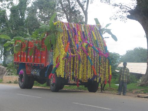Flower decorated truck - Have you seen a truck as well decorated as this one? Wondering how the driver can see through these flowers.