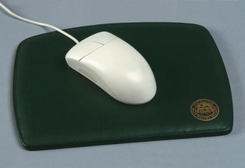mouse pad and a mosue - A black mouse pad with a white roller mouse lieing over it