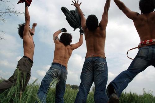 Rang De Basanti - The lead actors of the movie Aamir Khan, Siddhart, Kunal Kapoor and Sharman Joshi flipping their shirts high in the air