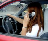 Cellphone use while driving - A girl is using CELLPHONE while driving