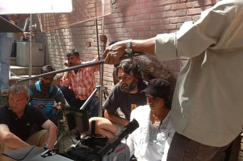 On The Sets: Rang De Basanti - The film-maker watching everything so that the shot can be clicked.