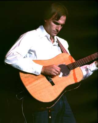 James Taylor - When people use the term 'singer/songwriter' (often modified by the word 'sensitive') in praise or in criticism, they're thinking of James Taylor. In the early '70s, when he appeared with his introspective songs, acoustic guitar, and calm, understated singing style, he mirrored a generation's emotional exhaustion after tumultuous times. Just as Bing Crosby's reassuring voice brought the country out of the Depression and through World War II, Taylor's eased the transition from '60s activism and its attendant frustrations into the less political, more inward-looking '70s. He was rewarded with a series of hit albums and singles (surprisingly, many of the latter were covers of old songs rather than his own compositions), and he managed to survive his initial fame to achieve lasting popularity. He continued to tour successfully for decades, and, starting with his 1970 breakthrough Sweet Baby James, all but one of his regular album releases for the rest of the century went gold or platinum, while his 1976 Greatest Hits album achieved a diamond certification reflecting sales of more than ten million copies.Taylor was the son of Dr. Isaac and Gertrude Taylor. His three brothers Alex (1947-1993), Livingston, and Hugh - and his sister Kate - all became musicians and recorded albums of their own. In 1951, Dr. Taylor was appointed dean of the medical school at the University of North Carolina at Chapel Hill, and the family moved from New England to the South. Taylor studied cello as a child, but first took up the guitar in 1960. In 1963, he began attending Milton Academy, a prep school in Massachusetts. That summer, he met fellow guitarist Danny 'Kootch' Kortchmar while staying on Martha' s Vineyard, and the two formed a folk duo. Taylor dropped out of school at 16 and formed a band with his brother Alex. Having moved to New York, he suffered from depression and checked himself into McLean Psychiatric Hospital in Massachusetts, a stay that would inspire some of his early songs. While there, he earned a high school diploma. Upon release, he returned to New York in 1966 and formed a new group, the Flying Machine, with Kortchmar and Joel O'Brien. The band played in Greenwich Village and was signed to a fledgling record label, Rainy Day Records (the name taken from Taylor' s song 'Rainy Day Man'). It released one single, 'Brighten Your Night with My Day' / 'Night Owl,' both songs written by Taylor. The record was unsuccessful, and the band broke up in the spring of 1967.