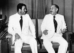Saddam - Saddam Hussein(left) talking with Ahmed Hassan al-Bakr(right)