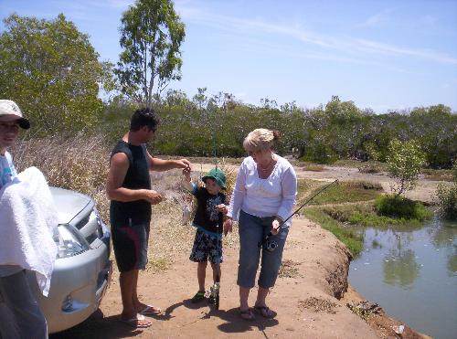 It was too small -  My grandson Liam with my son and his wife .Liam caught the first fish but it was too small