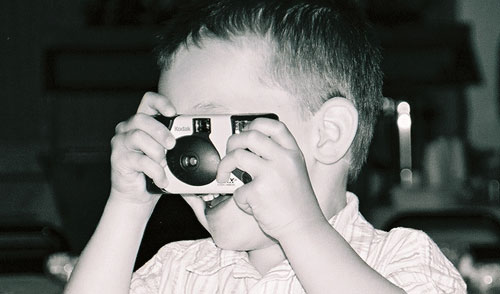 Little photographer - Here's a future photographer caught getting some practice at my brother's wedding.