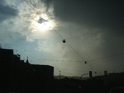 Rainy day - A rainy day at home. The cables are hung between walls of the houses and carry the street lights. I have taken this photograph through the windshield of my car, which returned these nice little water droplets all over the image.