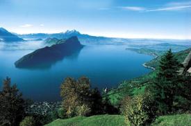 Mt. Pilatus, Pilatus, Central Switzerland -  Ride up the world's steepest cogwheel railway from Alpanachstad, and arrive onto the Dragon’s land of, Mount Pilatus (2132 m altitude). According to medieval legend, the corpse of Pontius Pilate was thrown into a small lake on this mountain. Dreams and fantasies come true on this peaceful Alpine peak. Nowhere do the stars sparkle more brightly or the sunsets more stunning than on the Pilatus Kulm. With a little luck you can spot ibex, chamois, colorful Alpine roses, arnica or gentian on your journey to and from the mountain. How to get there There are two ways of reaching this mountain from Lucerne.  From the Lucerne Railway Station, take trolley bus No. 1 to Kriens to the Pilatus stop (20 min.). Once here it is an easy 5 minute walk to the valley station in Kriens. Take the aerial gondolas to reach Fräkmüntegg, and then onto the summit. The Kriens - Fräkmüntegg -Pilatus route runs year-round. However, it will be closed for maintenance from mid Oct - early Nov.  From the Lucerne Railway Station go to Alpnachstad by train or from the Boat Pier outside the railway station take a boat (90 min). Look out for the «Pilatus» sign at the railway station. Take the cogwheel train to Mt. Pilatus. The journey up is half-an-hour. The journey down takes a careful forty minutes. This route is seasonal.  The trip of going up via Alpanachstad and coming down via Kriens or vice versa is called the Golden Round Trip from Lucerne. Experiences Christmas Market & Märliwelt - On 18 and 19 November, visit the colorful Christmas Market on Pilatus Kulm. Every year the popular event attracts around 4000 visitors from all over Central Switzerland and its neighboring areas. Visit the Märliwelt (Fairy-tale World), Advent attractions and enjoy the joyful Christmas carols and tasty festive food to satisfy all appetites. Frpm Saturday 11.00 hrs, Sunday 09.30 hrs (open until 16.00 hrs).  Toboganning on the Mountain Slopes - Get into the groove on Switzerland's longest summer toboggan run - 1350 meters of tempo and top-notch fun (in summer, in dry weather only). The racy ride down steep mountain slope in a shiny steel channel begins on Fräkmüntegg (1415 meters altitude). Plenty of cool steep curves, dragon holes and inbuilt mega jumps make every toboggan run an unforgettably fun experience.  Pilatus Seilpark - Central Switzerlands Biggest Suspension Rope Park. At Fräkmüntegg, Central Switzerland's largest rope park promises funfilled adventure for outdoor fans, families and clubs. There are 7 exercise trails with varying degrees of difficulty all through the forest. The Pilatus Rope Park offers a fun experience for outdoor fans, families, schools, companies and clubs. One trail is suitable for our smaller guests from age 8. No special abilities are needed to use the Pilatus Rope Park but it demands and promotes agility, concentration and determination.  Mt. Pilatus - Watch traditional alpine Cheese making in the early morning dew Experience 'live' traditional cheese making on the Alps (in June for groups on request). Not just for cheese connoisseurs! Take an early morning trip up to Mount Pilatus. En route stop by to look over the shoulder of a cheese-maker at his traditional craft. Here you will see the cheese maker make the cheese in a cauldron. You have the option of enjoying a hearty cheese maker’s breakfast here.  Dragon Path - The Dragon Path is a winding and curvaceous path around the mountain giving you a panoramic view of the alpine valley and the villages below. Enjoy an easy stroll along the Dragon Path through the rock gallery on Pilatus Kulm, or make a short detour to the Oberhaupt, the Esel or Tomlishorn. In summer, these Mount Pilatus peaks are accessible along good paths, within an easy 10 to 35-minute walk from the Mount Pilatus hotels.  'Live Alpenhorn performance' (May October) enjoy the sound of the Alpenhorns. This delightful Swiss folklore performance features traditional foot tapping music played by professional alpine horn blowers. Also displayed here is the largest alpine horn in Switzerland. (On weekends only)  Moonlight Dinner on Pilatus Kulm - Dine at 7000 feet above the Lake Lucerne. Here you have a choice of 4 set menus. Reservations for transportation and dinner must be confirmed 3 days in advance. This facility is available from mid May - mid November. The Food Palatte on Pilatus Mountaineer's Breakfast (June - September) Every Sunday between 08.00 and 11.00hrs. Savor a sumptuous breakfast with local specialties.  Pilatusstübli - Situated in the Hotel Pilatus-Kulm, built in 1900, the restaurant enchants guests with its very special ambience. In 1999 the building was placed under a protection order as a monument in Canton Obwalden worthy of preservation. Cozy and comfortable, the Pilatusstübli seats up to 50 guests.  Spiesshüsli (Pilatus Kulm terrace) - The Spiesshüsli is the ideal choice for a quick snack and a cool drink. Savor a tasty Bratwurst sausage and a refreshing beer garnished with a spectacular Alpine panorama!  Trendrestaurant Express (Hotel Bellevue) Behind the panes of glass of an original cogwheel railway carriage, our chefs prepare fresh pasta specialties before the eyes of our guests. The cheeky, comic metal figures by local Lucerne artist Gabi Kopp cater for an informal atmosphere.  Sunny terrace (Hotel Pilatus-Kulm) Enjoy piping hot coffee, cold draft beer straight from the taps, (brewed with mineral water from the mountains) fresh Alpine air and magnificent mountain views on the spacious sun terrace in front of the Hotel Pilatus-Kulm. Accomodation The Hotel Pilatus-Kulm, built in 1900, enchants guests with its very special ambience. In 1999, the building was placed under protection order as a monument in Canton Obwalden worthy of preservation . It has 23 rustic double room with running water, showers, WC on floors.  Marvel at the magnificent views of Lucerne, Lake Lucerne and the Alps from your room in the Hotel Bellevue (3 star) . This hotel built in 1960, has 28 comfortable double rooms with showers, WC, TV. Canton Obwalden worthy of preservation. It has 23 rustic double room with running water, showers, WC on floors.