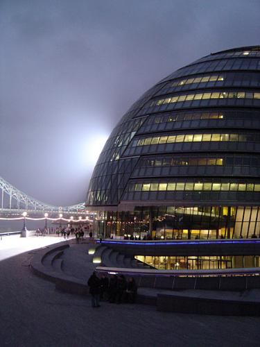 City hall london - This picture was a complete fluke. I was walking past City Hall one evening and noticed that a movie was being shot in front of it - the floodlights happened to all be on one side of the building, hence the unusual lighting effect. The building looks very otherworldly at the best of times; it's always reminded me of the alien mothership from ET. The strange light gives the impression that it's just landed and ET is about to walk out of it... --