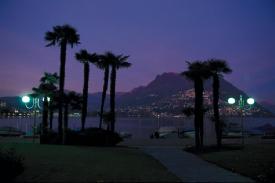 Lugano, Ticino -  Lugano in southeast Switzerland, in the Italian speaking canton of Ticino, borders Italy. The city has a distinctively Italian character with a distinct Mediterranean climate of sunny days and mild winters. Surrounded by mountains and a splendid lake, Lugano brings together all the characteristics of a metropolis with a great lifestyle. The city is framed on all sides by wooded, sugar-loaf hills rising from the water that have led to its being dubbed the 'Rio of the Old World'. Lugano also brings honor to the culinary culture and is particularly endowed with excellent restaurants, praised by the most important gastronomic guides. Must See Must Do Locarno - a city on the northern tip of Lake Maggiore hosts the annual International Film Festival every August in the Piazza Grande. The open air film screening at the Piazza accommodates the crème de la crème of the international film fraternity. The most coveted awards of the festival op are the 'Golden Leopard' or the 'Pardo d'oro,' awarded to the best film. Other awards include the Silver Leopard (second place), and the Bronze Leopard (for best actor and actress). An approximate 500 films are screened over a span of 11 days.  The Olive Path - This path was built in 2002 by 'Friends of the Olive Tree' 'Amici dell'Olivo' and threads its way through several little plantations of young olive trees between Gandria and the centre of Castagnola. The path is indicated on green signs and winds along the lakeside displaying rare and ethereal beauty. Most of the trees and shrubs come from the Mediterranean area: olive trees, green cypresses, bay trees, myrtle, pomegranate, Mayaca palm, marine pines, and flowered laurels. At ground level a marvelous spread of wild herbs - oregano, thyme, sage, as well as daisies, carnations, evergreens, daffodils and wild tulips create a multicolored patchwork counterpane that the visitor will never forget. This display is repeated each year in spring in the months of May and June.  Mendrisio - Fox Town - Only 15 kilometers from Lugano, Fox Town is a shopaholics' delight! 'Big brands for small prices' is their motto thus setting up a mega mall of designer wares at factory outlet rates. Since the Factory Outlet Center shopping is already a proven theory in the United States these retail spaces offer the most famous international companies offer their products at factory prices directly to the customer, with a discount from 30% to 70%. Generally open through the week it houses name brands like Dior, Lacoste, Hugo Boss etc.  Swiss Premium - Alprose - A member of 'Chocosuisse', Alprose is amongst the largest chocolate producing companies in Switzerland. Using the best of the ingredients for their high quality milk chocolate, they produce three different varieties of chocolate. Visitors are taken for a grand tour of the factory, inhaling in the rich creamy aroma of the delicious chocolate. One can learn more about chocolate making from the various comments and photographs set up in the museum. Chocolat Alprose SA, 6987 Caslano (091 611 88 88)