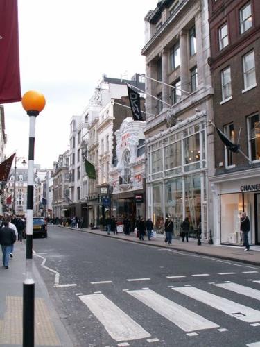 New Bond Street 2 db - Within the City of Westminster, the entertainment district of the West End has its focus around Leicester Square, where London film premieres are held, and Piccadilly Circus, with its giant electronic advertisements. London's theatre district is here, as are many cinemas, bars, clubs and restaurants, including the city's Chinatown district, whilst just to the east is Covent Garden, an area housing speciality shops and London's 'Avenue of Stars' which honours achievers in the entertainment industry. Shoreditch and Hoxton in the East End form a second, less mainstream, focus of bars, nightclubs, restaurants and galleries. Angel Islington's 2km long Upper Street has more bars and restaurants than any other street in the UK. It was also the first street in the UK to have wireless enabled for its cafe's.  London's busiest shopping area is Oxford Street, a shopping street nearly 2 km long which makes it the largest shopping street in the World. The adjoining Bond Street in Mayfair is a more upmarket location along with the Knightsbridge area - home to the Harrods department store - to the southwest. The districts of Knightsbridge (Sloane Street), Mayfair (Bond Street, Brook Street), and Chelsea (King's Road) represent London's prestigious role in the world of fashion, being an international centre of fashion alongside Paris, Milan, New York and Tokyo. Furthermore, London has a number of markets, including Camden Market for fashions, Portobello Road for antiques and Borough Market for foods.  London offers a huge variety of cuisine as a result of its ethnically diverse population. Gastronomic centres include the Bangladeshi restaurants of Brick Lane and the Chinese food of Chinatown. Soho offers a variety of restaurants, whilst more upmarket restaurants are scattered around central London, with concentrations in Mayfair. Across the city, areas home to particular ethnic groups are often recognisable by restaurants, food shops and market stalls offering their local fare, and even the large supermarkets stock such items in areas with sizeable ethnic groups.  The Caribbean-descended community in Notting Hill in West London organises the colourful Notting Hill Carnival, Europe's biggest street carnival, every summer. The beginning of the year is celebrated with the relatively new New Year's Day Parade, whilst traditional parades include November's Lord Mayor's Show, a centuries-old event celebrating the annual appointment of a new Lord Mayor of the City of London with a procession along the streets of the City, and June's Trooping the Colour, a very formal military pageant to celebrate the (official) Queen's Birthday.