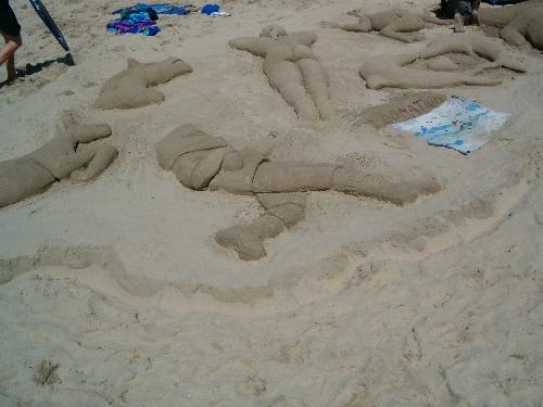 South Africa - Margate Beach, Sand Sculptures - When living in South Africa, we often went down to the Coast on holiday, there were most times some form of contest for the kids to participate in, and this was one of them. The Picture shows a Shark playing rugby (there was a team called the Sharks, and as their logo it was a Shark playing rugby, with a rugby ball under its fin) There is also a Springbok, Springbok being a South African Mascot for all Rugby, as it is the Mascot for our International Team. There is also 2 beautifully sculptured dolphin's with there noses pressing, makeing a heart shape, and a heart in the center. There is a woman suntanning, ofcourse, your on the beach, and the sculpture is really detailed, showing the woman on the beach soaking up the sun. There is a horses head, this was done by a little girl, she was around the age of 6, it was her first time on the beach, and her and her mum did that beautiful sculpture of a horses head. There is also a sculpture of a frog, if i remember correctly, a boy of around the age of 16 did that one.