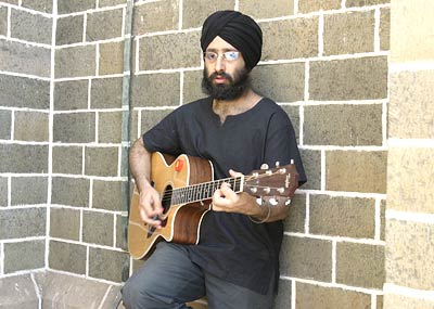 Rabbi playing guitar - Rabbi is a punjabi rock singer. here is a pic catching him in a very different mood