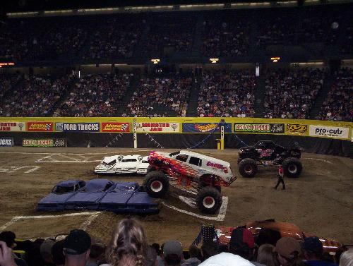 Monster Jam 2004 - Eradicator and Demolition Man go at it and Eradicator is in the lead.