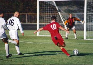 Football - A boy about to kick a ball towards the goal post