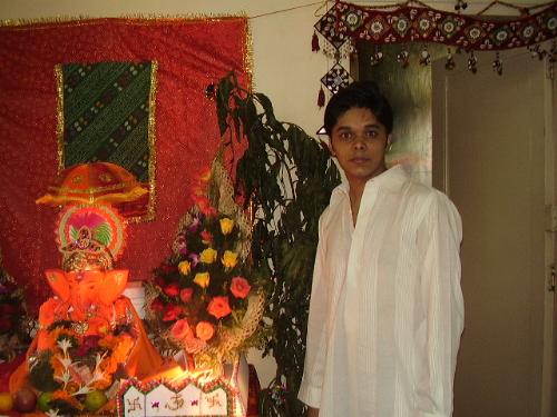 Ganpati with his fan - It was Ganpati festival going on when my sweet bhabhi clicked the pic. I was wearing a long Kurta which was very royal.   But no doubts my confidence i.e. Lord Ganesha idol is looking better than me...