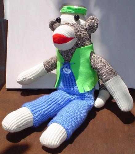 Don&#039;t hate me because I&#039;m beautiful. - Sockmonkey with crocheted outfit.