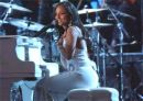 Norah Jones - photo of Norah Jones sitting at piano in concert