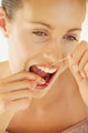 Floss - woman flossing teeth