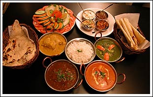 Indian Food and Spices - Here we have pictured is a table with some indian food and spices on it.