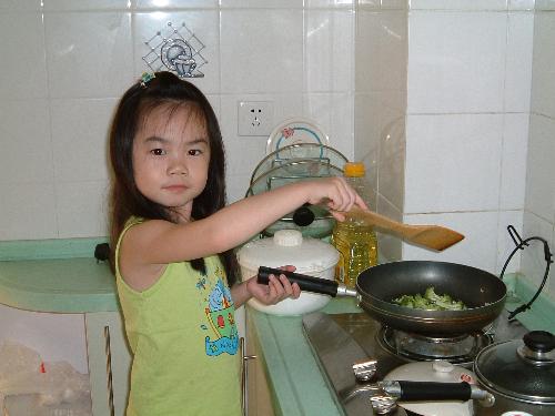 Cooking - My daughter having a fun time stir frying vegetables. She was about 5 then.