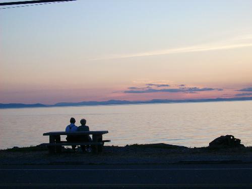 sunset in love - a couple on a bench, watching the sunset at Birch Bay, WA, USA
