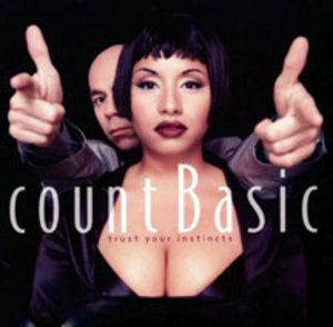 count basic : cd design  - count basic cover shows women&#039;s face bolstered by the low cut dress she wore showcasing her significant cleavage and man behind her giving two thumps up!
great cd design